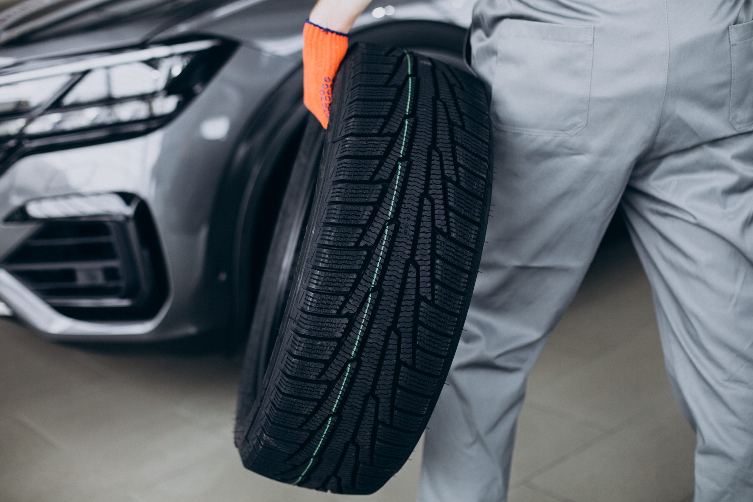 Mechanic changing tires in a car service Mechanic changing tires in a car service